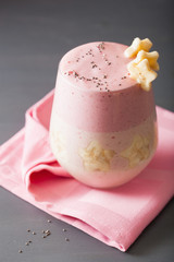 healthy layered raspberry banana smoothie in glass