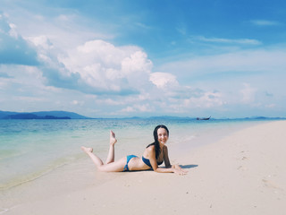 Fototapeta na wymiar Beautiful woman in bikini laying on the paradise beach