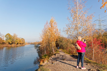 Locals hiking and photographing at autumnal banks of Old Rhine
