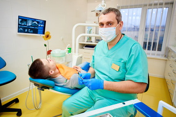a man in a chair at the dentist, dental office, dental treatment