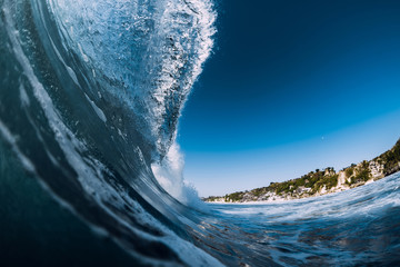 Barrel wave crashing in ocean. Blue wave for surfing
