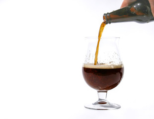 Pouring dark beer into glass