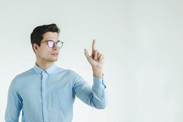 Handsome man pointing finger up.