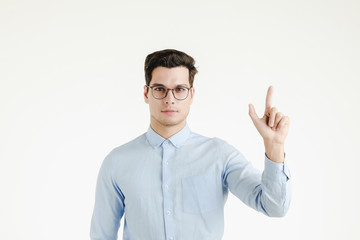 Handsome man pointing finger up.