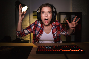Nervous angry young woman gamer playing
