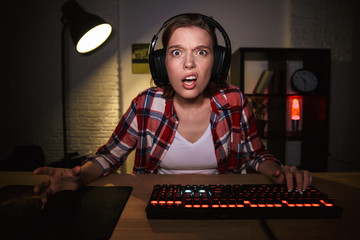 Nervous angry young woman gamer playing