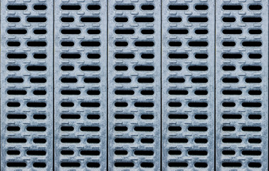 Metal drainage holes pattern. Grunge industrial grate texture.