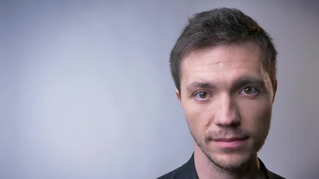 Closeup of face of attractive caucasian man with brown eyes and neutral facial expression