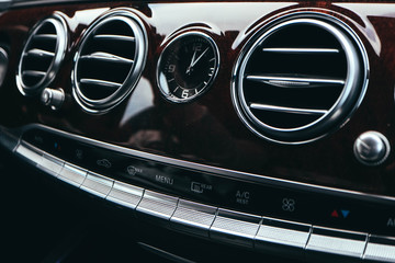  Luxury car dashboard, air conditioner, clock, buttons.