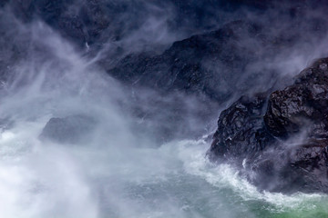white water and dark rock create abstract mist pattern
