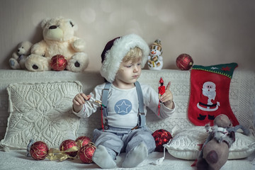 Baby is playing with New Year's toys