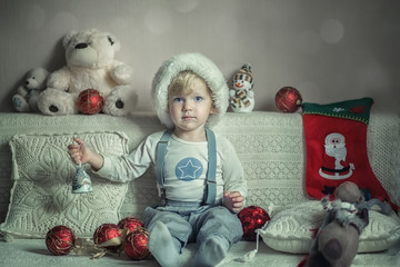 Baby is playing with New Year's toys