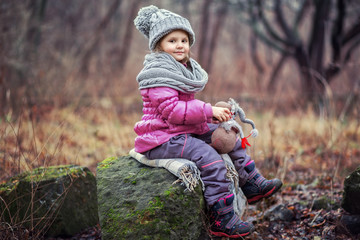 Little girl walks in the park