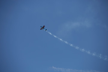 Small airplane doing aerial acrobatics in a exhibition