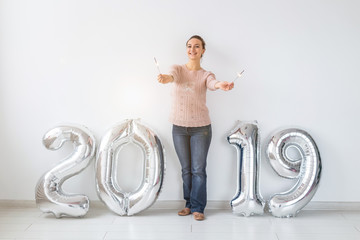 Party, people and new year holidays concept - woman celebrating new years eve 2019 with and sparklers