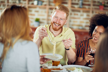 Friends having dinner at restaurant. Multi ethnic group.