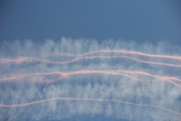 Fototapeta na wymiar Trail of colorful smoke left behind by planes during an air show