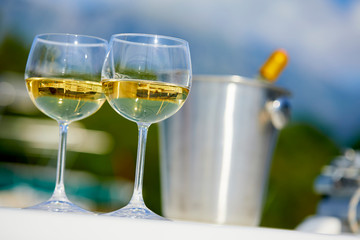 Pair of wineglasses against the yacht