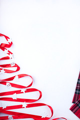 Christmas tree of ribbons on the New Year's table. Light background. Free space for text.