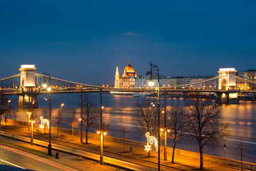 Night view of Budapest riverfront street against chain bridge and Parliament
