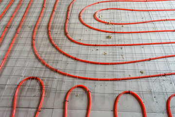 Tubes of the underfloor heating system on a styrofoam insulation