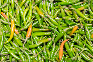 green and orange chili or peppers for sale in the Vegetable market.