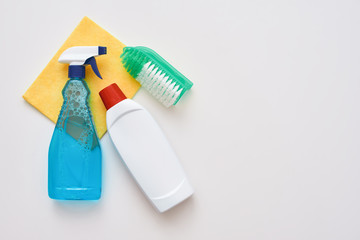 Cleaning tools. Spray bottle and orange cleaner cloth and brush isolated