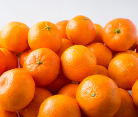 Fresh tangerines. Ripe and tasty mandarins. Clementines. Background tangerines. Clementines on white background.