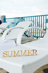 Word summer on beach chair 