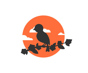 bird sitting on a tree branch on a sunset background beautiful icon logo vector