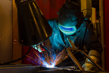 Industrial steel welder in factory welder, craftsman