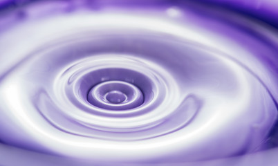 Mixing paints of different colors, drops and splashes close-up