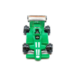 Photo of green toy model car isolated on white background