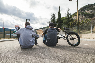 Young people with bikes and skateboards in the city. Urban and extreme sports for young people