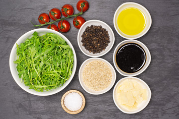 Ingredients. recipe step by step arugula salad flatlay on grey stone