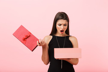 Upset woman wearing black dress holding empty gift box