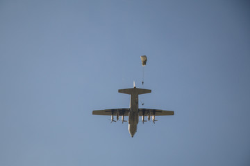 Airplane and paratroopers with parachutes in the sky .Military parachute jumper in the sky.