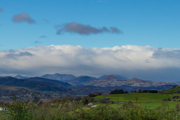 Fototapeta premium Mountain range in clear weather in contrasting rain clouds before the rain