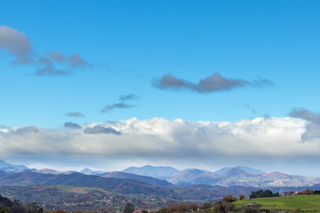 Mountain range in clear weather in contrasting rain clouds before the rain