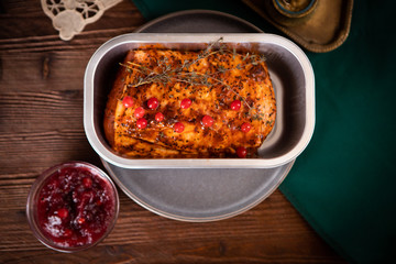 Top view on baked marinated pork with thyme and berries