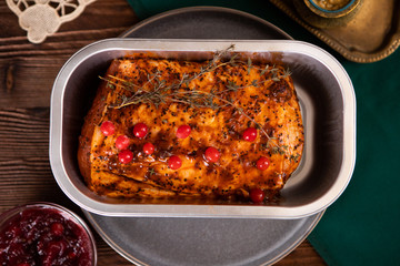 Top view on baked marinated pork with thyme and berries