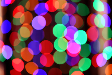 Blurred view of beautiful lights on dark background