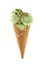 Waffle cone with delicious ice cream and pistachios on white background