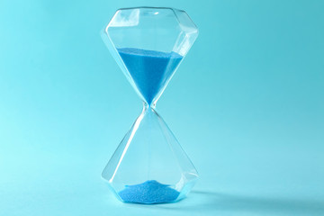 Hourglass on color background. Time management concept