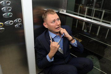 Businessman having panic attack in elevator