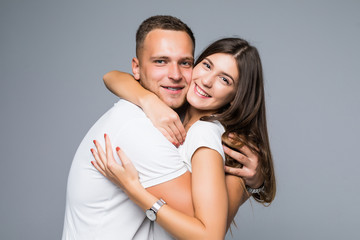 Portrait lovely sensual couple hugging, sexy girl looking at camera isolated on grey background