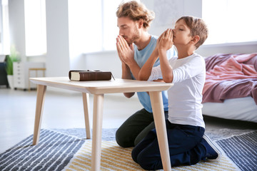 Father with son praying at home