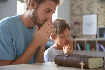 Father with son praying at home