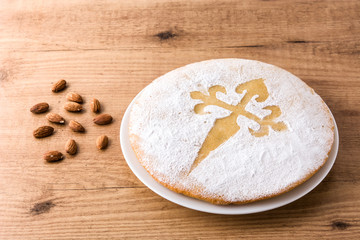 Tarta de Santiago. Traditional almond cake from Santiago in Spain on wooden table