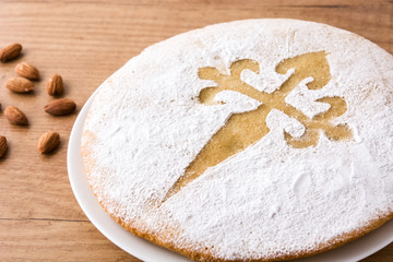 Tarta de Santiago. Traditional almond cake from Santiago in Spain on wooden table